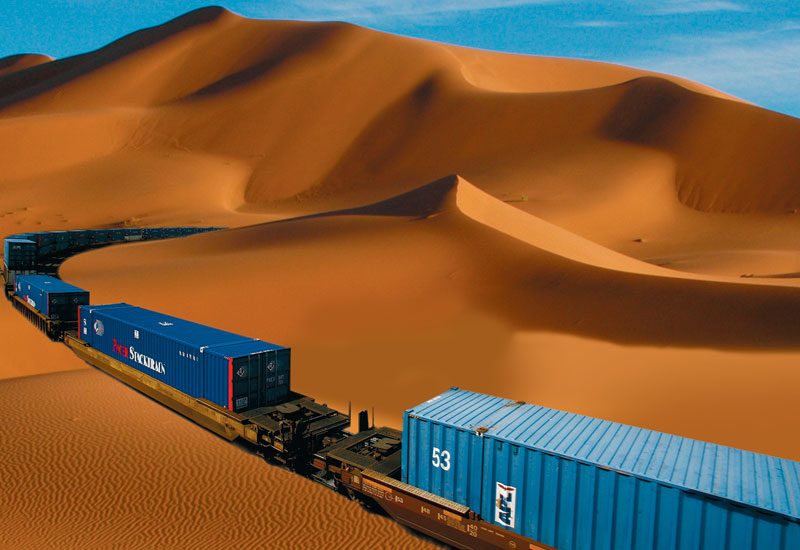 Etihad Rail freight train crossing desert dunes